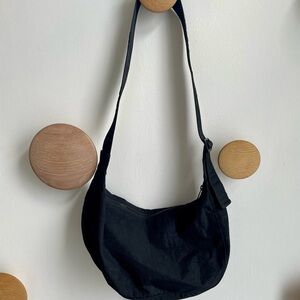 BAGGU Medium Crescent Bag in black nylon with tonal logo strap